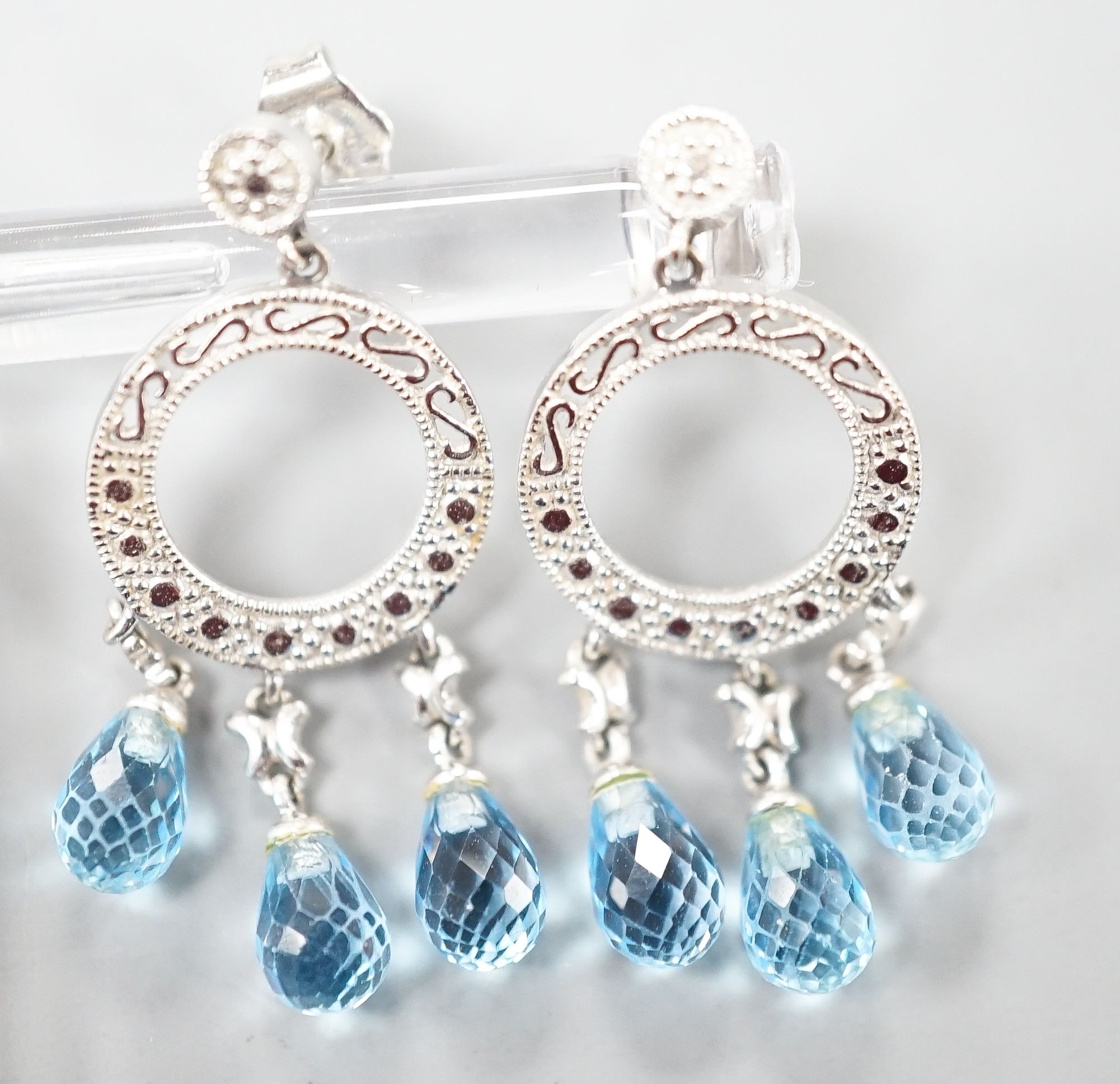 A pair of 14k white metal, diamond chip and three stone facetted blue topaz set drop earrings, 31mm, gross weight 4.5 grams.